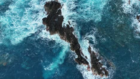 Slow-motion-drone-video-in-Porto-Moniz-Madeira-where-waves-hits-a-rock-and-splashes