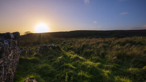 Timelapse-of-rural-nature-farmland-with-old-stonewall-ruin-during-dramatic-cloudy-sunset-evening-viewed-from-Carrowkeel-in-county-Sligo-in-Ireland