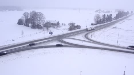 Maxima-cargo-truck-drives-on-snow-blizzard-pass-of-Alexela-gas-station-on-Estonian-main-highway