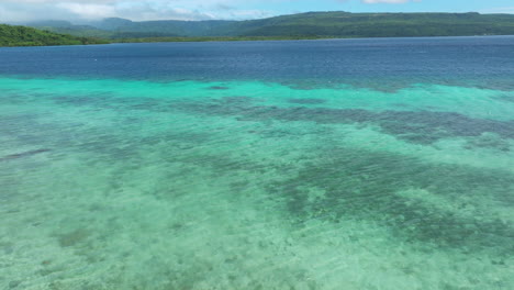 Flying-Over-Crystal-clear-Blue-Water-Of-Moso-Island,-North-Efate,-Vanuatu