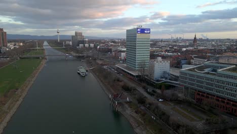 Aerial-view-dolly-in-of-the-MVV-Building-and-the-museum-ship-on-the-river-Neckar