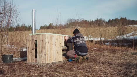 Man-In-The-Process-Of-Building-His-DIY-Hot-Tub---Close-Up