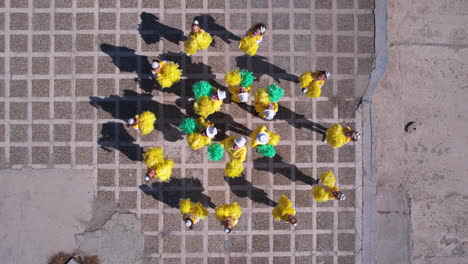 Top-Down-Drone-Shot-of-Majorette-Girls-in-Yellow-Uniforms-and-Pom-Poms