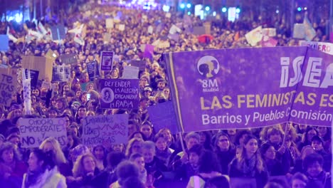 Thousands-of-people-march-during-a-demonstration-on-International-Women's-Day-at-nighttime