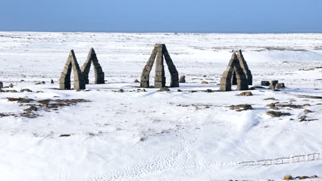 Parallax-drone-view-of-Stonehenge-monument-in-winter-time-in-Iceland-on-a-sunny-day