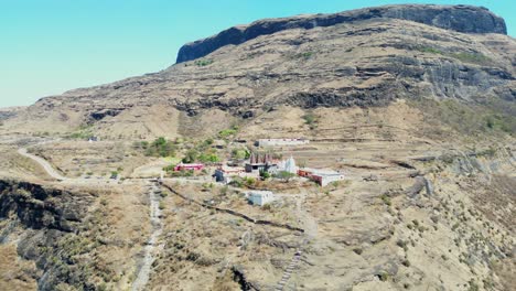 drone-moving-closer-to-longh-from-hindhu-temple-in-top-on-hill-in-Maharashtra-Kalsubai-Peak-Chandwad-Fort