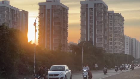 pov-shot-Many-people-are-carrying-bikes-and-four-wheels-and-high-rise-buildings-are-also-visible-in-the-background-which-are-getting-sunlight