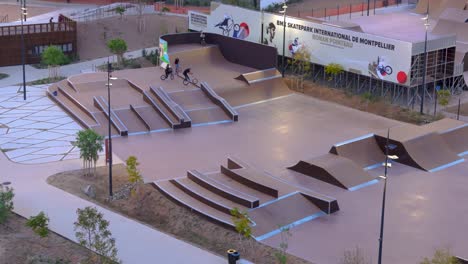 Aerial-rotation-view-of-Kids-on-skate-park-in-Montpellier,-France