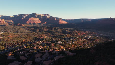Sedona,-Arizona-USA-at-Sunrise,-Aerial-View-of-Homes-and-Houses-in-Valley-Under-Scenic-Red-Rock-Hills
