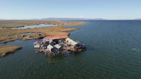 Aerial-view-of-Uros-Floating-Islands-on-Lake-Titicaca,-the-highest-navigable-lake-in-the-world,-on-the-border-of-Peru,-South-America
