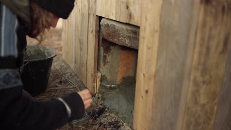 The-Man-is-Applying-Cement-to-the-Stove-Beneath-the-DIY-Hot-Tub---Timelapse