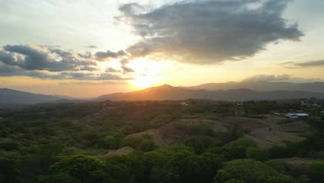 Drone-Shot-Towards-Beautiful-Sunset-Over-Mountains-on-the-Horizon