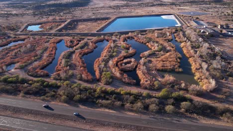 Drone-Shot-of-Sedona-Wetlands-Preserve,-Sewage-Water-Treatment-Location-and-Facility-by-State-Route-Road,-Arizona-USA