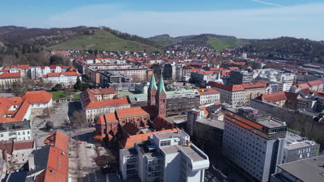 Drone-Shot-of-Maribor-Slovenia,-Cityscape-and-Out-Mother-of-Mercy-Catholic-Church