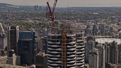 Vancouver-BC-Canada-Aerial-v111-drone-fly-around-The-Butterfly-residential-complex-under-construction-with-panoramic-views-of-cityscape,-harbour,-mountain---Shot-with-Mavic-3-Pro-Cine---July-2023