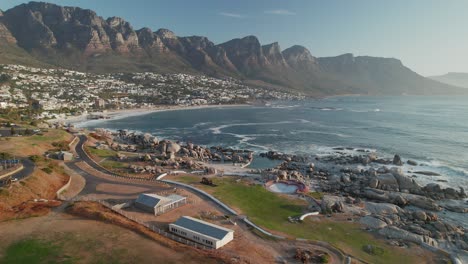 Camps-Bay-Suburb,-Beach,-Tidal-Pool-And-12-Apostles-Mountains-In-Cape-Town,-South-Africa