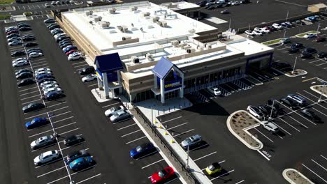 Wide-Aerial-Drone-Footage-of-a-new-CARMAX-dealership-in-smithtown-long-island-ny-on-a-sunny-day