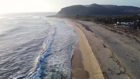 Baja-California-Sur-Mexican-beach-with-waves-breaking-on-Pacific-Ocean-shoreline-during-sunset