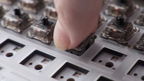 Fingers-placing-switches-on-a-mechanical-keyboard