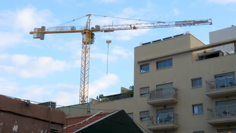 Construction-cranes-towering-over-urban-apartments