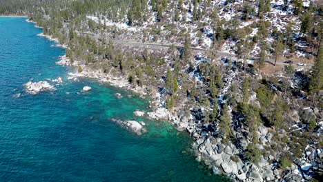 Aerial-view-of-clear-blue-water-and-shoreline-at-Lake-Tahoe,-California