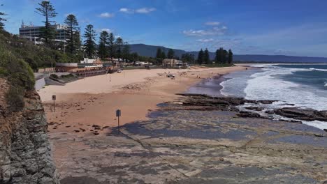 Aerial-view-of-North-Wollongong-Beach-Surf-Club-and-the-waves-crashing-on-sand-and-rocks