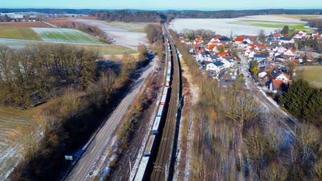 Winter-Train-Route-Beside-Frost-Covered-Village-Homes