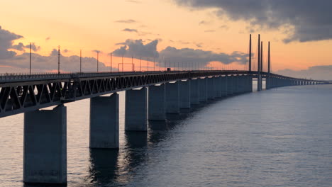 Twilight-drone-riser-at-iconic-Oresund-bridge-reveals-traffic-and-two-ships