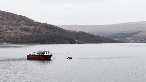 Fishing-boat-floating-gently-anchored-on-Loch-Eil-in-Fort-William,-Scotland