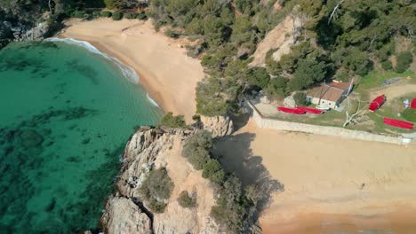 Dive-into-Lloret-De-Mar's-aerial-panorama,-capturing-the-allure-of-its-turquoise-sea,-sandy-beaches,-and-exclusive-destinations-like-Santa-Cristina-and-Cala-Treumal
