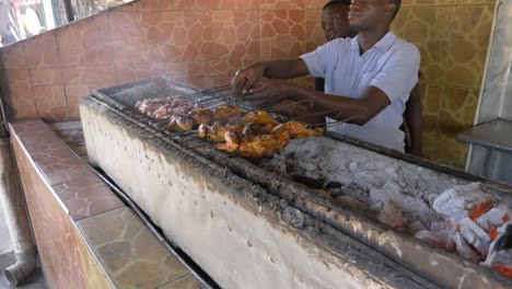 African-males-handling-the-Meat-Barbecue