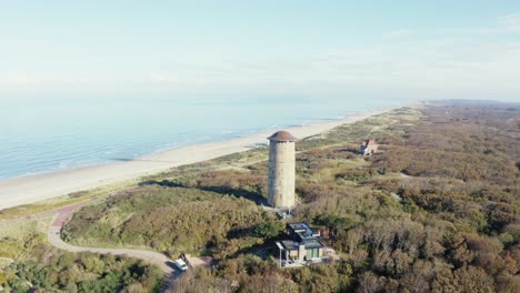 Aerial-shot-of-tower-in-Domburg,-zeeland-with-ocean-view