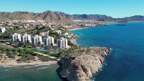 Beach-Hotel-Resorts-at-Coast-in-Isla-Plana,-Cartagena,-Murcia,-Spain---Aerial-4k