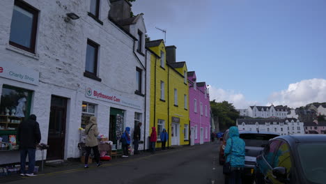 Portree,-Isle-of-Skye,-Scotland-UK,-People-on-Coastal-Street-and-Colorful-Buildings,-Slow-Motion