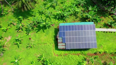 Descending-on-a-house-in-the-middle-of-the-forest-with-a-solar-system-on-the-roof,São-Tomé,Africa