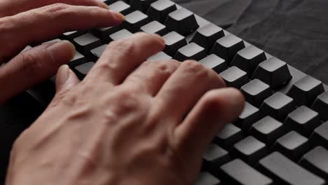 Hands-typing-rapidly-on-a-mechanical-keyboard,-focus-on-fingers,-tactile-feedback,-work-environment