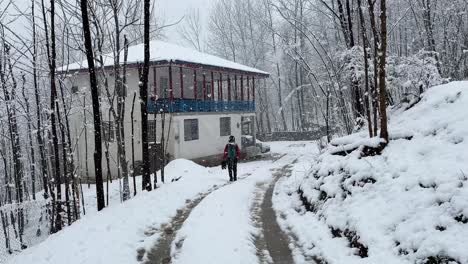 Return-to-home-after-a-wonderful-exciting-hiking-adventure-in-heavy-snow-in-Hyrcanian-forest-in-Iran-the-old-ancient-house-in-countryside-village-life-local-people-living-concept-in-mountain-region