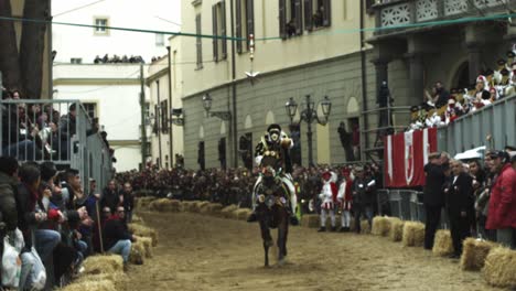 Su-Componidori-horse-riding-at-the-Sartiglia-feast-and-parade,-Oristano-carnival,-Sardinia,-Italy-Rider-in-slow-motion