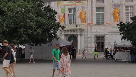 Turistas-Caminando-Cerca-Del-Palazzo-San-Giorgio,-Cerca-Del-Antiguo-Puerto-De-Génova,-Porto-Antico
