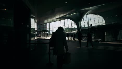 Persons-in-black-silhouette-leaving-Dutch-train-station-in-backlight-high-contrast