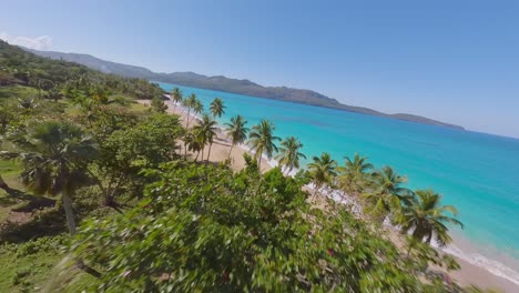 Fpv-drone-flight-over-Tropical-island-of-Dominican-Republic-with-sandy-beach-and-turquoise-Caribbean-sea-in-summer
