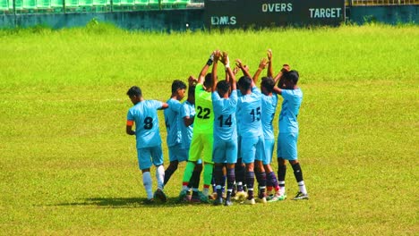 Football-Team-on-the-ground-at-beginning-cheering-for-motivation