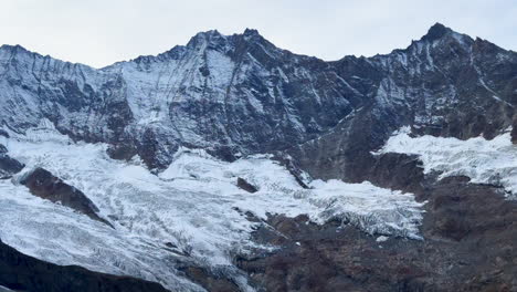 Saas-Fee-Saastal-Zermatt-glacier-peaks-ski-resort-Switzerland-Swiss-Alps-Alpine-Valley-glacial-peaks-summer-autumn-fall-Platen-Alphabet-Taschorn-cloudy-blue-hour-evening-sunset-slow-pan-left