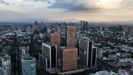 Aerial-view-circling-the-Miyana-Complex,-dramatic-evening-in-Polanco,-CDMX