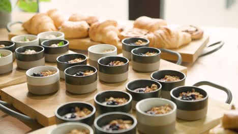 Hotel-breakfast-buffet-spread-featuring-overnight-oats-and-croissants,-ideal-for-a-nutritious-morning-start