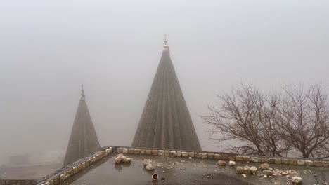 Misty,-foggy,-rainy-day-in-Lalish,-Kurdistan-Iraq-overlooking-the-Yazidi-Temple-spires
