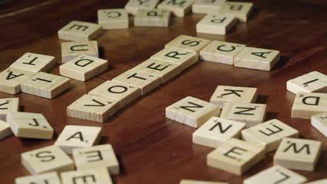 Scrabble-tile-letters-used-to-create-crossword-of-VOTER-and-SCAM-words
