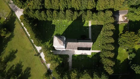 big-church-on-a-green-meadow,-cemetery,-visby,-sweden,-drone