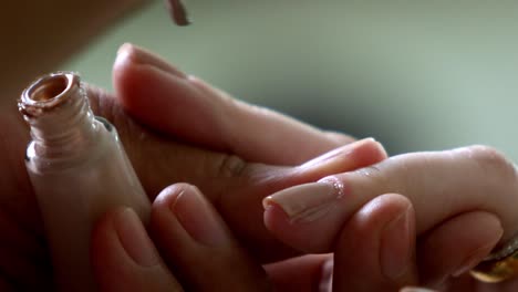 applying-varnish-on-nail-polish-in-close-shot,-slow-motion-manicure,-luxury-treatment