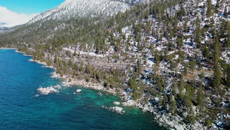 Aerial-reveal-of-mountain-top-at-Lake-Tahoe-coastline